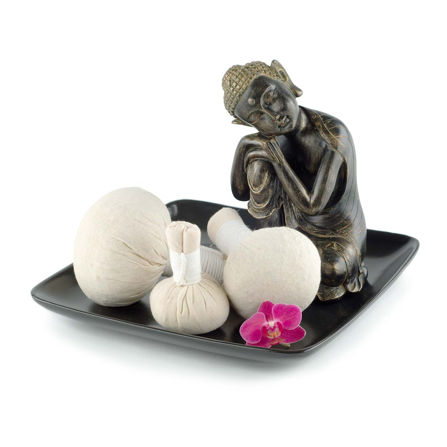 Thai hot massage compresses on a tray with a thoughtful Buddha statue.