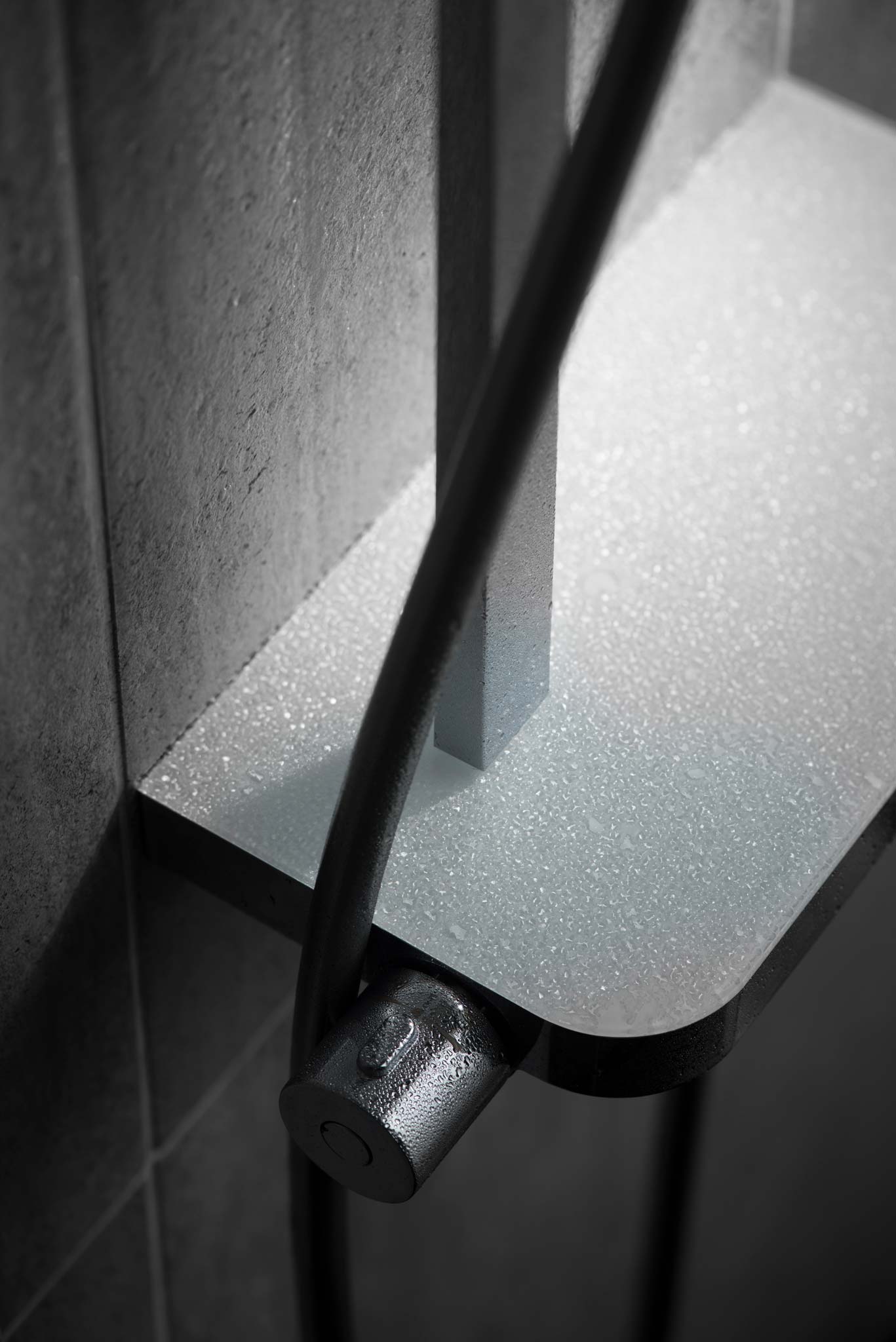 Overhead photograph of an integrated shower valve with shelf covered in water droplets