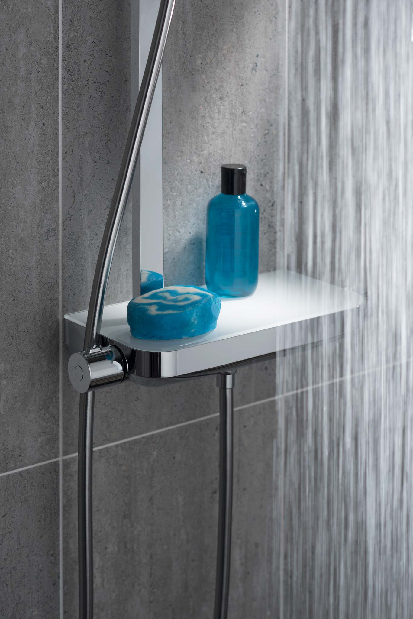 Integrated shower valve with shelf and blue soap and shower gel bottle