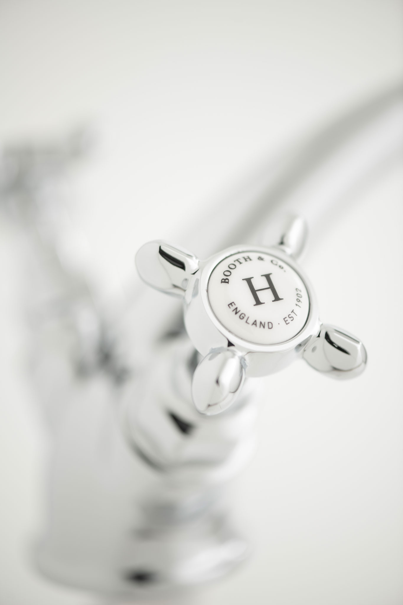 Traditional basin mixer hot handle close up
